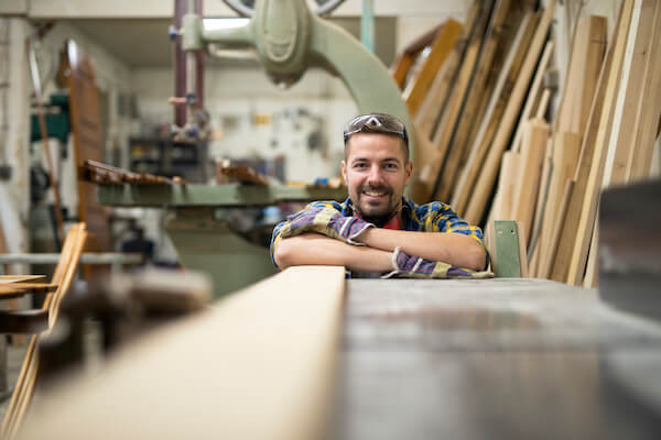 Man looks down a sheet of plywood