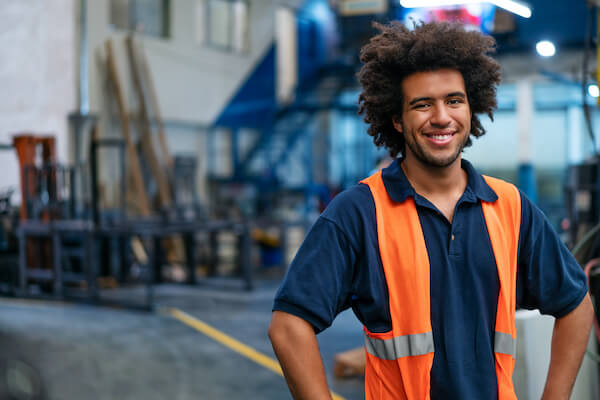 A man wearing a safety vest on a construction site