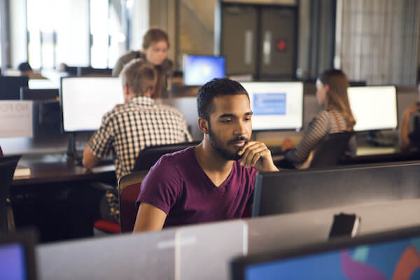 man sitting in computer lab