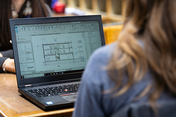 A laptop screen seen over a student's shoulder.