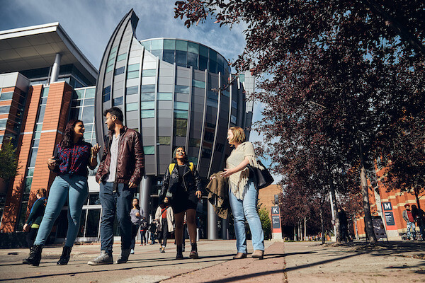 People walking outside SAIT's Johnson Cobbe building