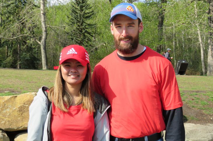 a female and male alumni volunteer standing together