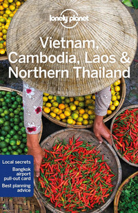 Book cover image for Vietnam, Cambodia, Laos & Northern Thailand with a photograph of a person wearing a traditional hat amid baskets of colourful fruit and veg, witha basket of red chillies in front of them.