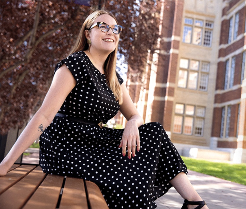 Madeleine MacDonald sitting on a bench looking off camera