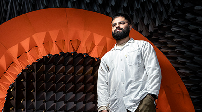 Umer standing in front of a textured surrounding