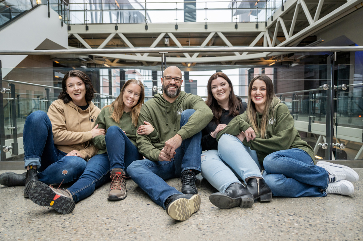 students sitting on floor smiling
