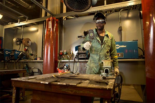 A steamfitter pipefitter apprentice in a SAIT lab.
