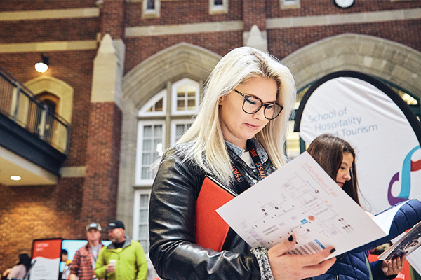 student looking brochure